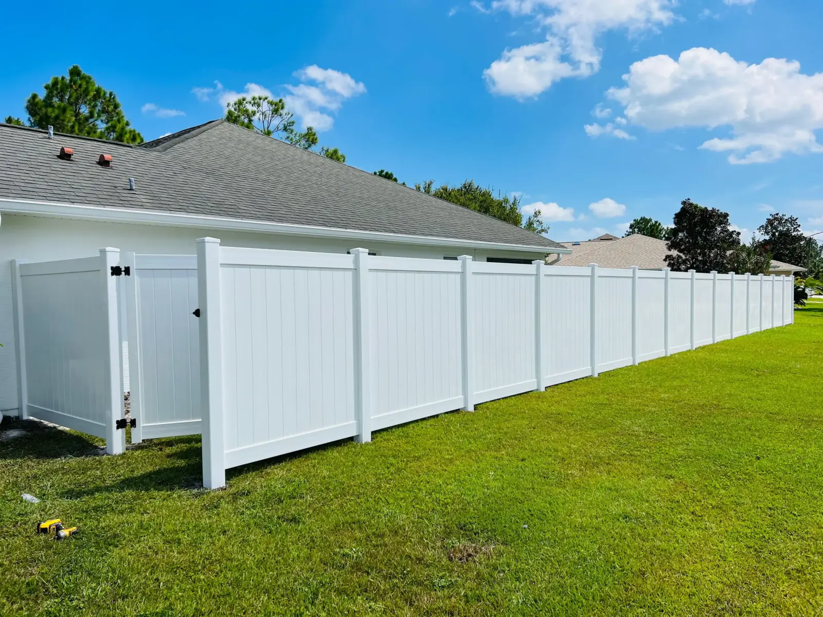 Black aluminum fence installation with the Roman Fencing work truck on site
